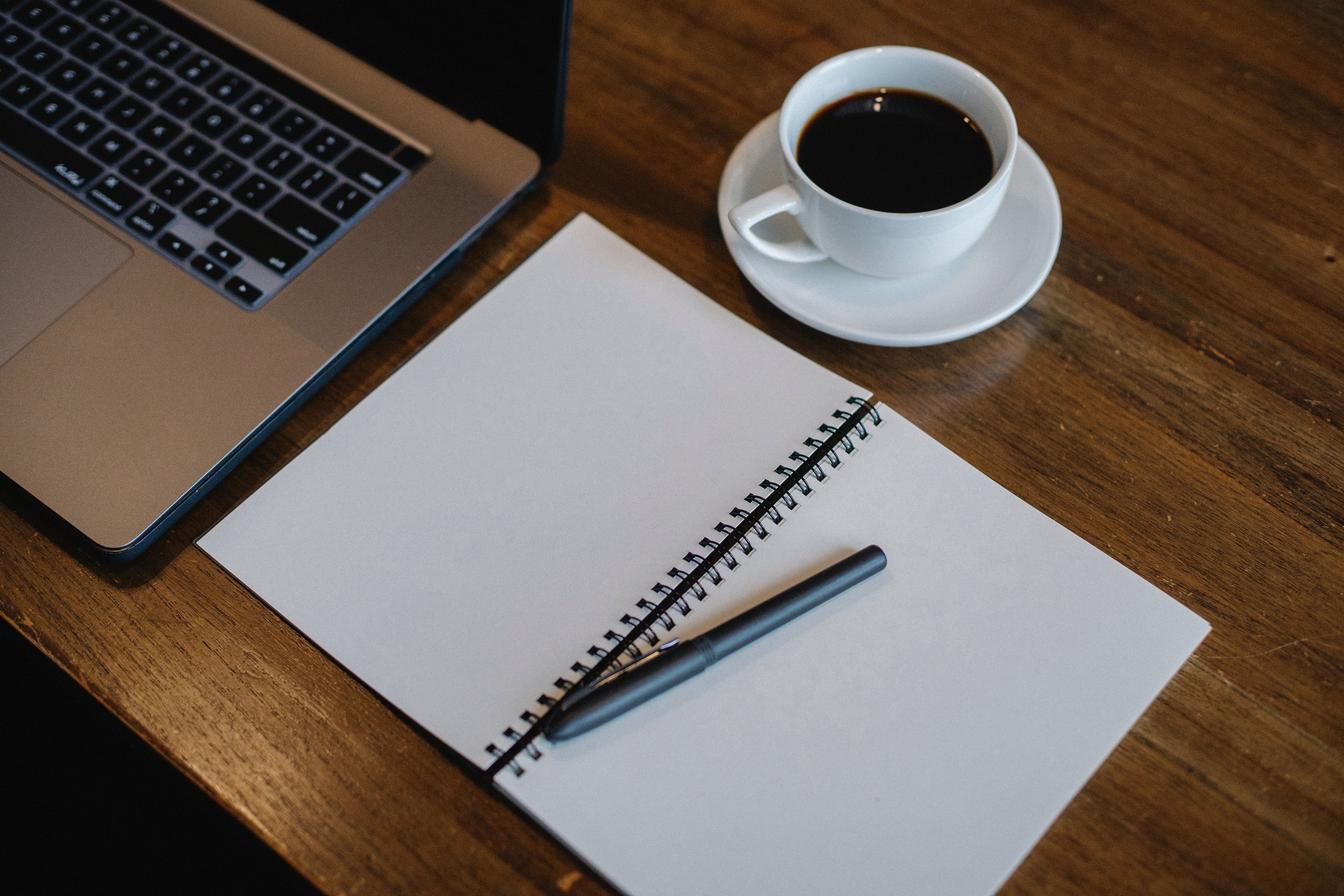Notepad, coffee and laptop - great tools for writing up your app ideas!